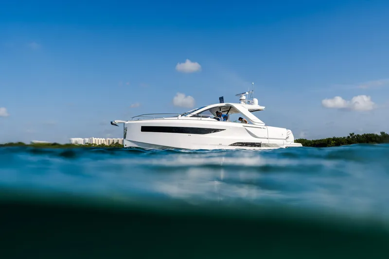 Slide: The Image of 2024 Jeanneau DB 37 OB yacht on calm blue water under clear sky. - 3