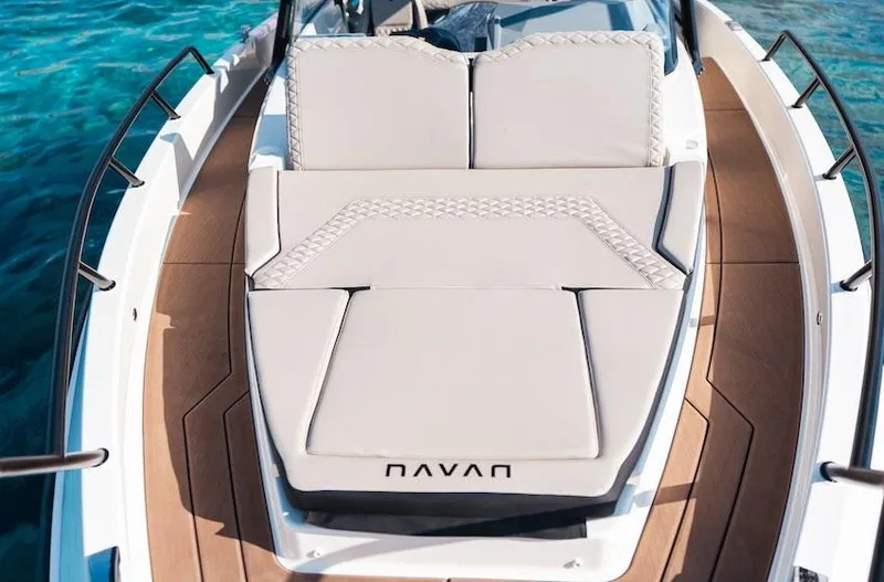 Slide: The Image of 2025 Navan S30 boat with cushioned deck, surrounded by clear blue water. - 15