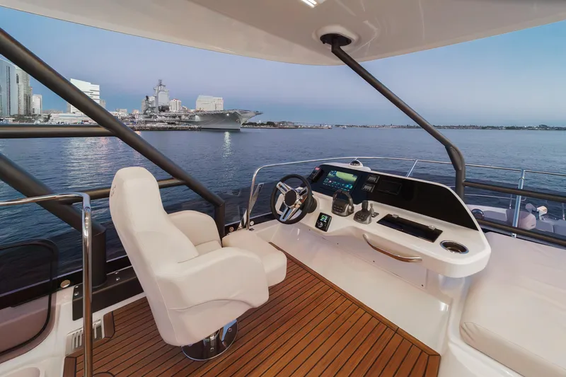 Slide: The Image of Luxurious 2025 Prestige F4.9 yacht helm with cityscape and ocean view. - 23