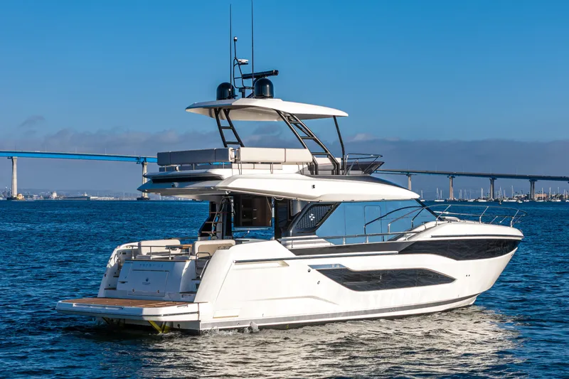 Slide: The Image of Luxury 2025 Prestige F4.9 yacht cruising on open water with bridge in background. - 3