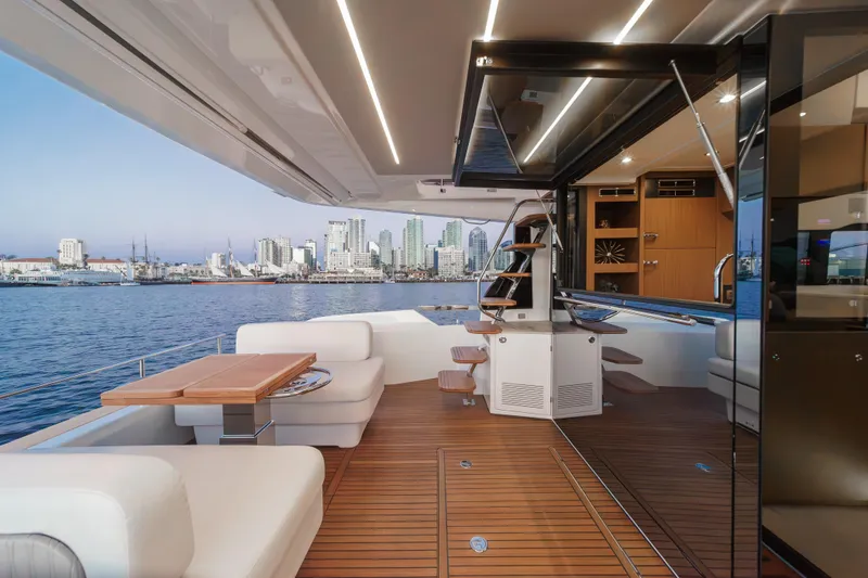 Slide: The Image of Luxurious 2025 Prestige F4.9 yacht interior with city skyline view, featuring elegant wood finishes. - 34