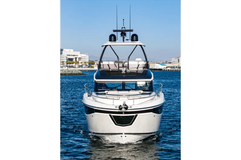 Slide: The Image of Front view of 2025 Prestige F4.9 yacht on water, clear blue sky background. - 4