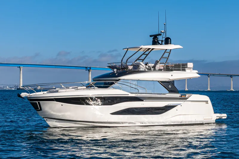 Slide: The Image of Luxury 2025 Prestige F4.9 yacht cruising near a scenic bridge on a sunny day. - 41