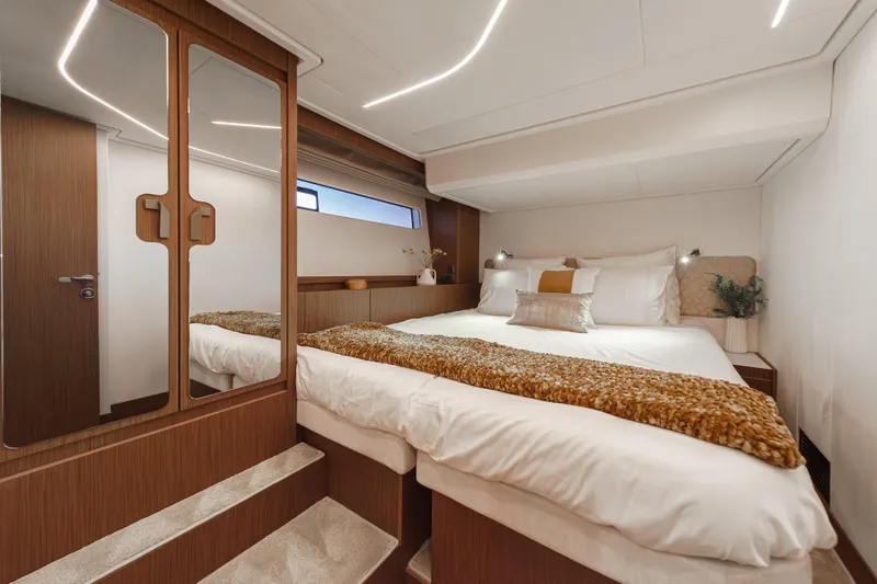 Slide: The Image of Luxurious bedroom interior of 2025 Prestige F4.9 yacht with modern design and cozy bedding. - 9