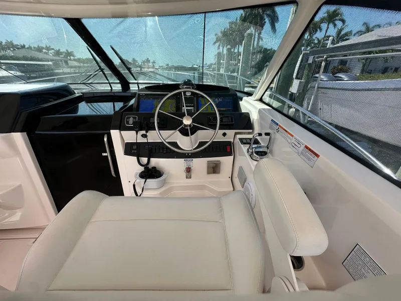 Slide: The Image of Helm of 2018 Tiara Yachts 4300 Open with modern controls and comfortable seating. - 16