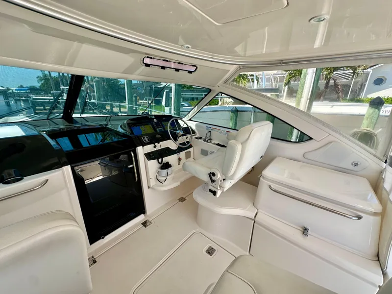 Slide: The Image of 2018 Tiara Yachts 4300 Open interior with sleek white seating and modern helm. - 19