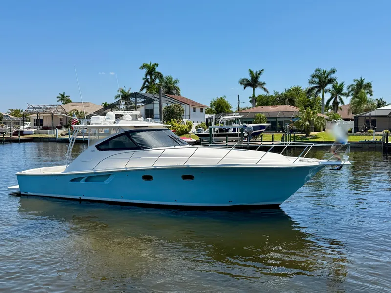 Slide: The Image of 2018 Tiara Yachts 4300 Open cruising on a sunny day near waterfront homes. - 6