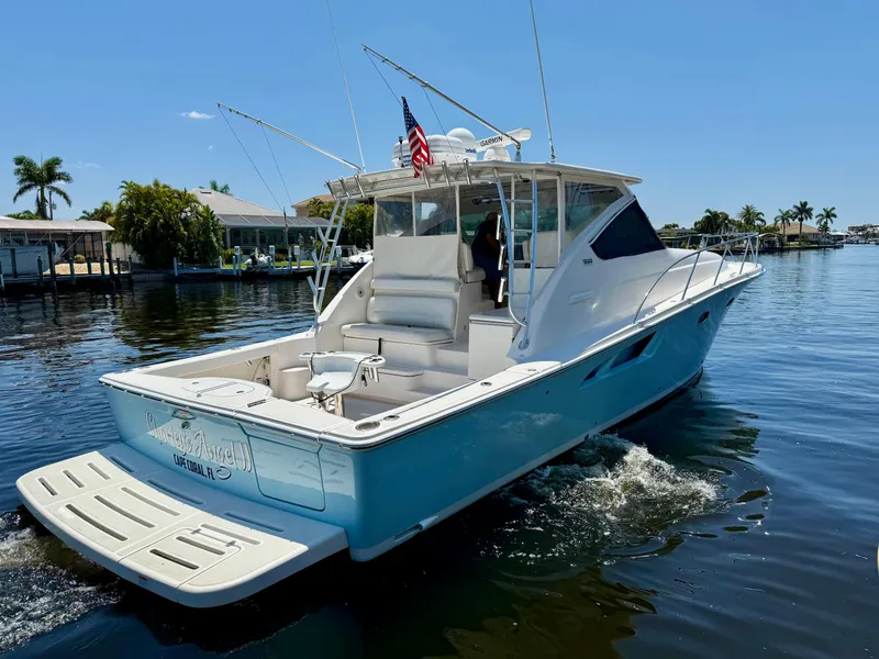 Slide: The Image of 2018 Tiara Yachts 4300 Open cruising on a sunny day in a scenic waterway. - 7