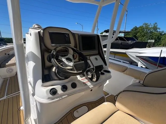 Slide: The Image of 2016 Glasstream 360 SCX boat helm with steering wheel and navigation controls. - 12