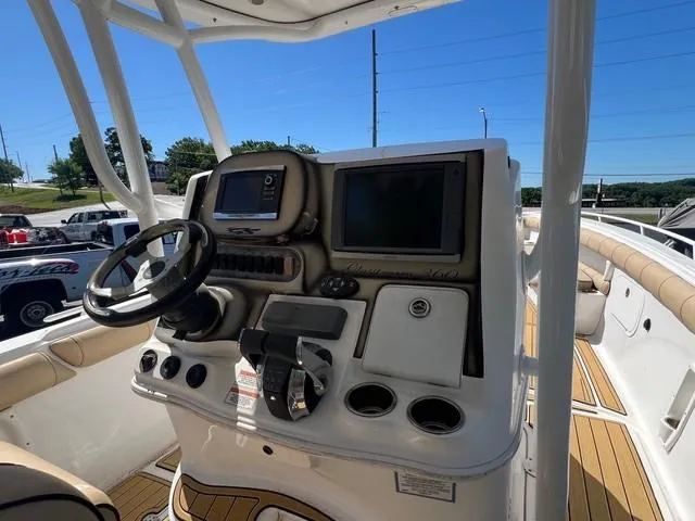 Slide: The Image of 2016 Glasstream 360 SCX boat dashboard with steering wheel and navigation screens. - 13