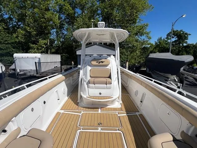 Slide: The Image of 2016 Glasstream 360 SCX boat with spacious deck and seating, surrounded by trees. - 17