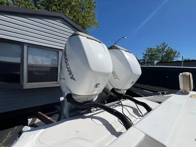 Slide: The Image of Twin Mercury outboard engines on a 2016 Glasstream 360 SCX boat, parked near a building. - 6