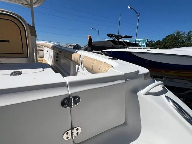 Slide: The Image of 2016 Glasstream 360 SCX boat interior with white and beige seating, docked under clear blue sky. - 8