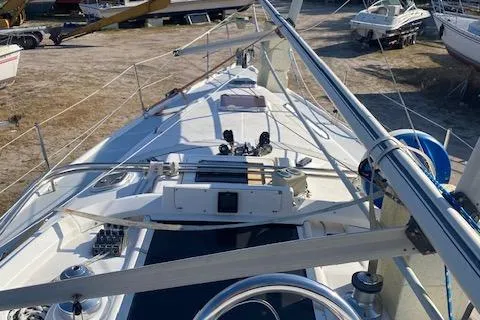 The Image of 1999 Hunter Passage 420 sailboat deck view, showcasing rigging and steering wheel. - 0