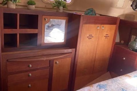 Slide: The Image of Interior of 1999 Hunter Passage 420 yacht with wooden cabinetry and decorative plants. - 16