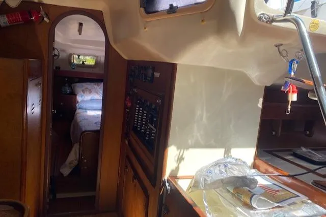 Slide: The Image of Interior of 1999 Hunter Passage 420 sailboat, featuring cozy cabin and navigation panel. - 7