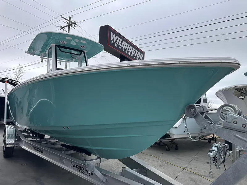 The Image of 2024 Sportsman Masters 267OE Bay Boat in teal on trailer at dealership. - 0