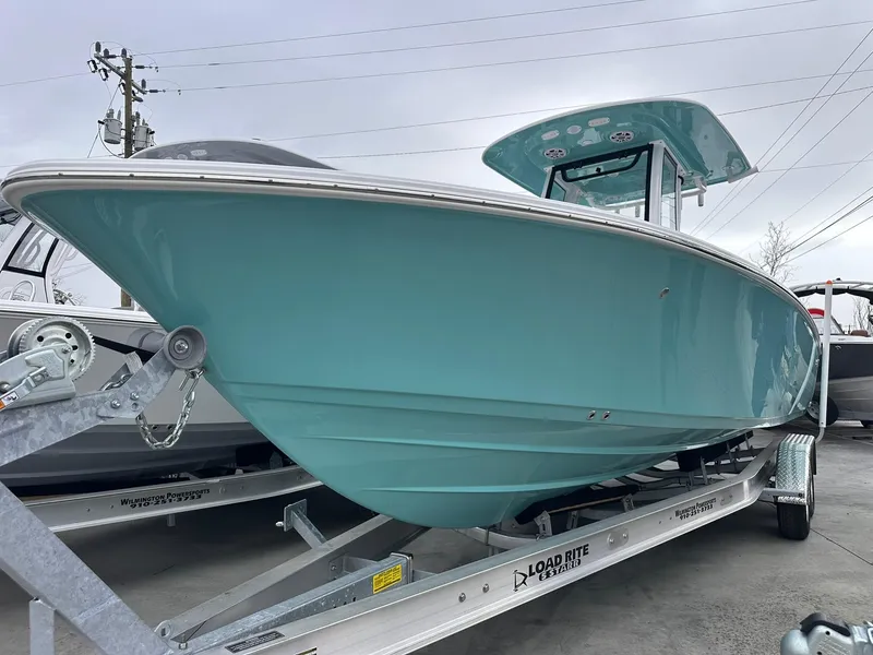 Slide: The Image of 2024 Sportsman Masters 267OE Bay Boat in teal on trailer. - 1