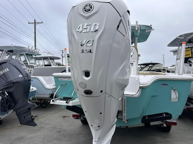 Slide: The Image of 2024 Sportsman Masters 267OE Bay Boat with Yamaha 450 V8 engine, docked outdoors. - 10