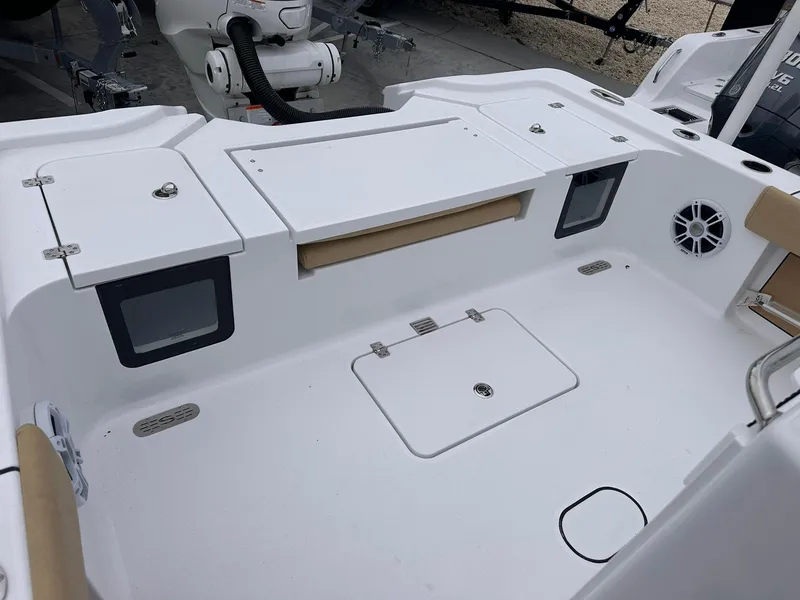 Slide: The Image of 2024 Sportsman Masters 267OE Bay Boat deck with storage compartments and speaker. - 17