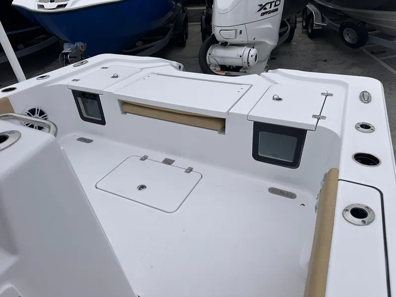 Slide: The Image of 2024 Sportsman Masters 267OE Bay Boat deck with storage compartments and motor. - 18