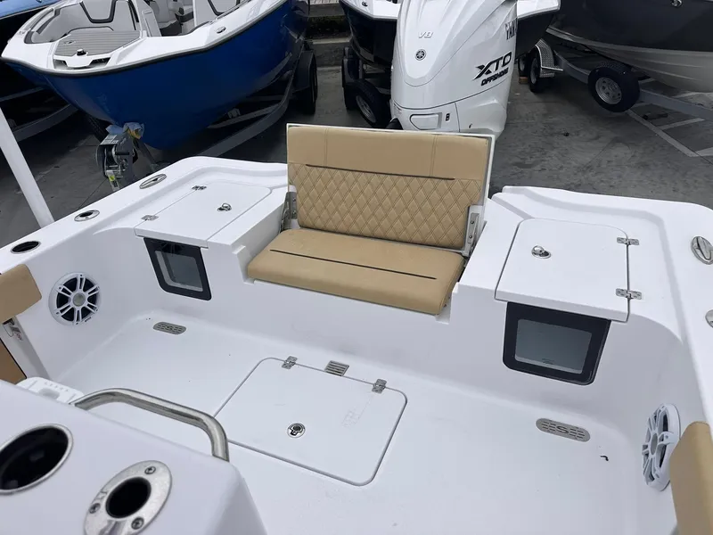 Slide: The Image of 2024 Sportsman Masters 267OE Bay Boat interior with tan seating and storage compartments. - 20