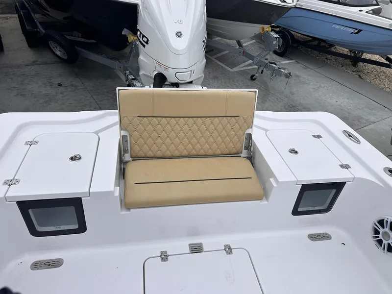 Slide: The Image of 2024 Sportsman Masters 267OE Bay Boat with beige seating and storage compartments. - 22