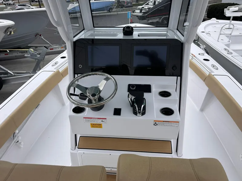 Slide: The Image of 2024 Sportsman Masters 267OE Bay Boat console with dual screens and steering wheel. - 25