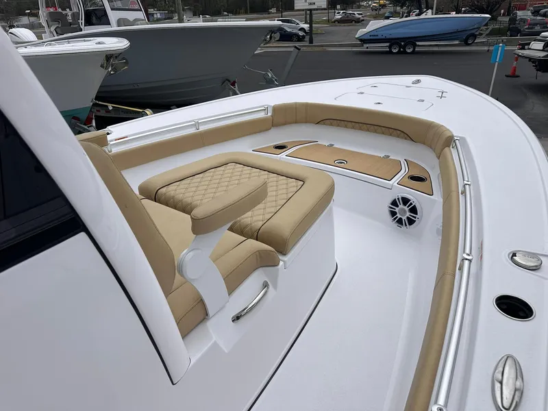 Slide: The Image of 2024 Sportsman Masters 267OE Bay Boat with tan seating and sleek white deck design. - 28