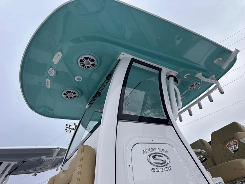 Slide: The Image of 2024 Sportsman Masters 267OE Bay Boat with teal canopy and modern design. - 3