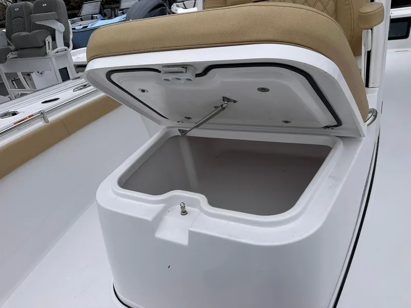 Slide: The Image of 2024 Sportsman Masters 267OE Bay Boat storage compartment with open lid and cushioned seat. - 34