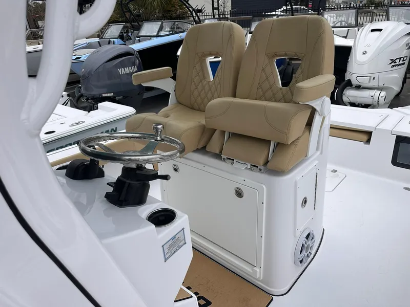Slide: The Image of 2024 Sportsman Masters 267OE Bay Boat with dual tan seats and steering console. - 38