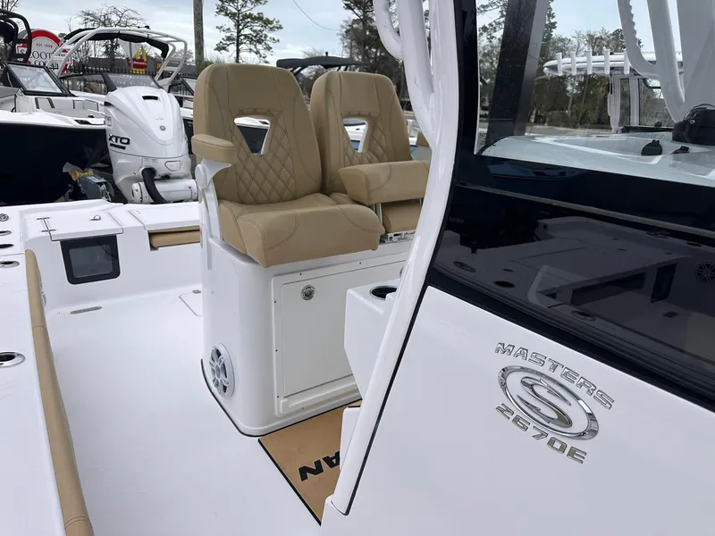 Slide: The Image of 2024 Sportsman Masters 267OE Bay Boat interior with tan seating and modern design. - 39