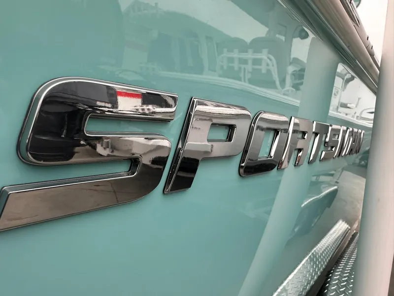Slide: The Image of 2024 Sportsman Masters 267OE Bay Boat logo on light blue hull. - 5