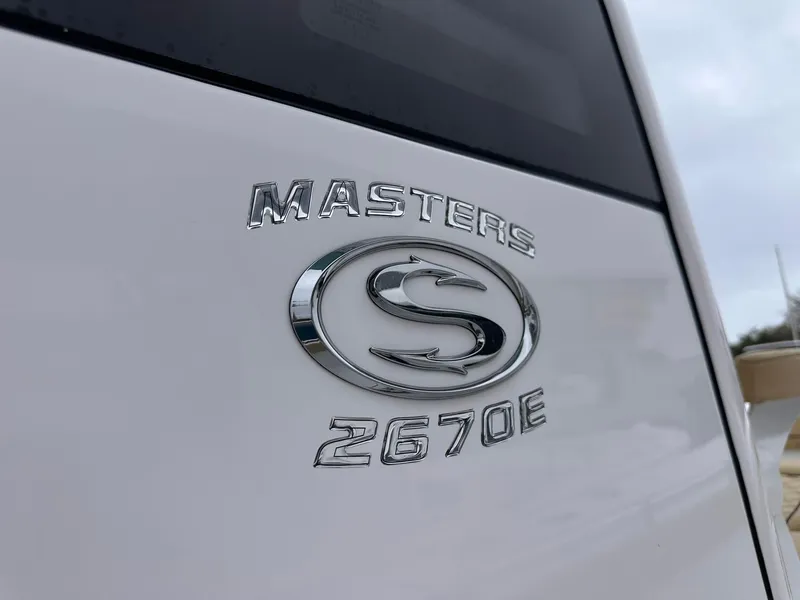 Slide: The Image of 2024 Sportsman Masters 267OE Bay Boat logo on white surface. - 6