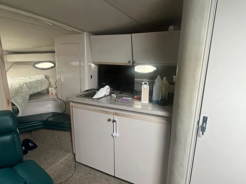 Slide: The Image of 1993 Regal 9.8 VENTURA boat interior with kitchenette and sleeping area. - 16