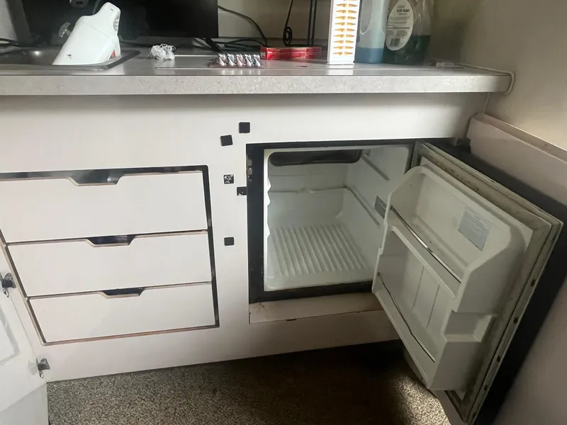 Slide: The Image of Open mini fridge in a 1993 Regal 9.8 VENTURA boat interior. - 18