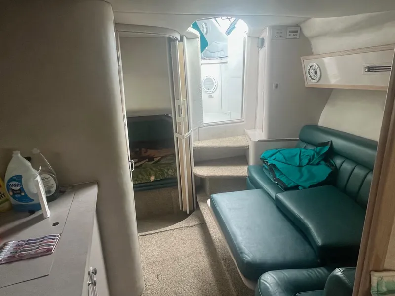 Slide: The Image of Interior of 1993 Regal 9.8 VENTURA boat with green seating and carpeted flooring. - 19