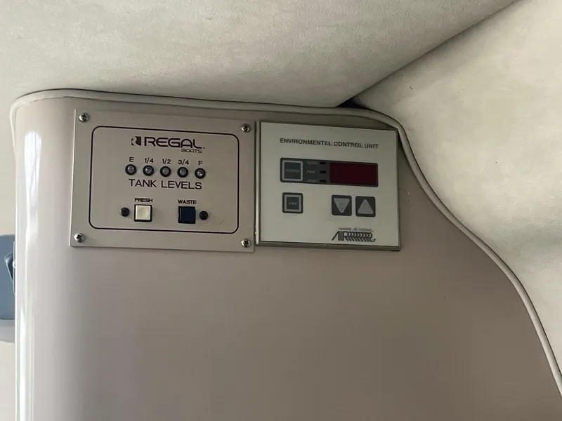 Slide: The Image of Control panel of a 1993 Regal 9.8 VENTURA boat, showing tank levels and environmental controls. - 20