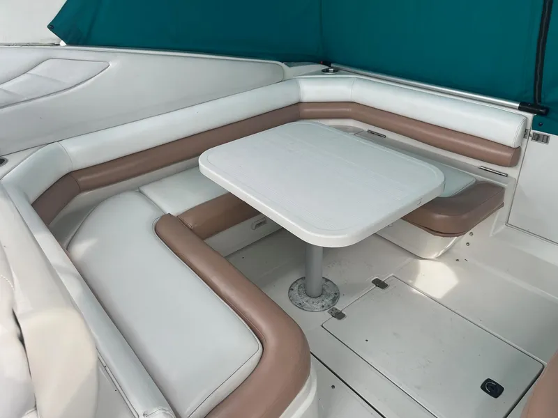 Slide: The Image of 1993 Regal 9.8 VENTURA boat interior with cushioned seating and table. - 4