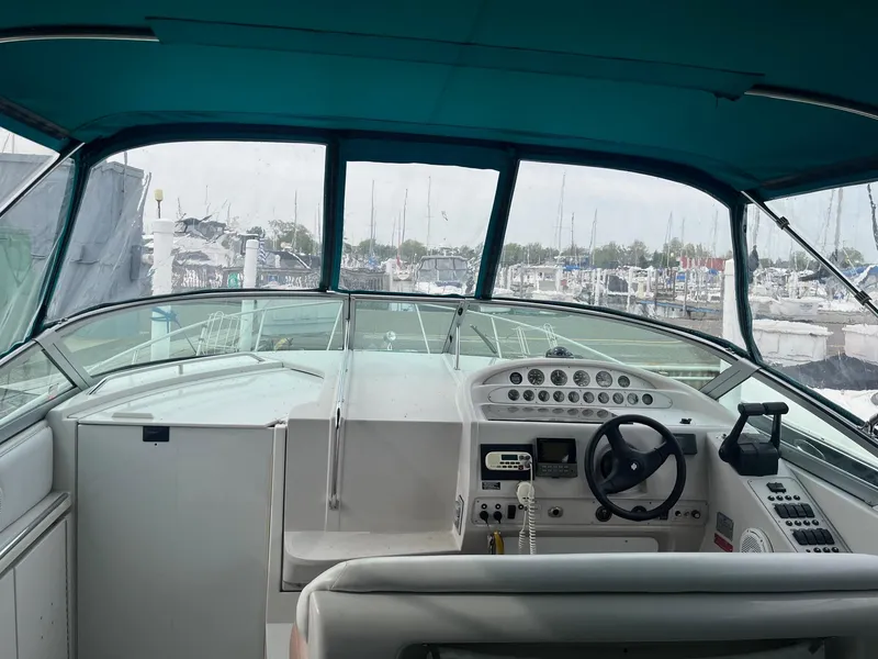 Slide: The Image of Cockpit view of a 1993 Regal 9.8 VENTURA boat with marina background. - 6