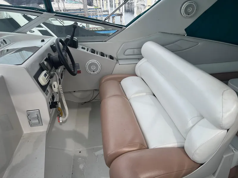 Slide: The Image of Interior of a 1993 Regal 9.8 VENTURA boat with white and brown seating. - 7