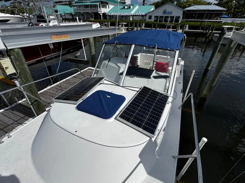 Slide: The Image of 2005 Albin 26 Tournament Express boat with solar panels docked at marina. - 15