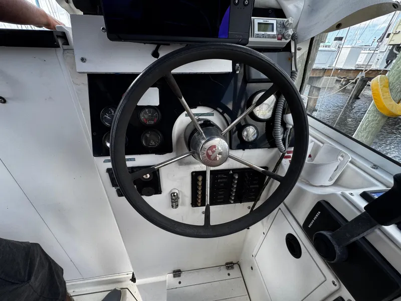 Slide: The Image of 2005 Albin 26 Tournament Express helm with steering wheel and control panel. - 4