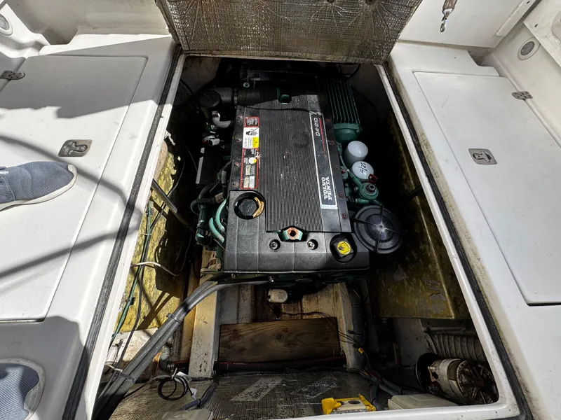 Slide: The Image of Engine compartment of a 2005 Albin 26 Tournament Express boat, showcasing detailed machinery. - 7