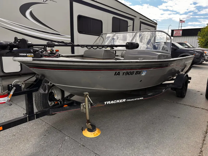 Slide: The Image of 2006 Tracker Pro Guide V-17 WT boat on trailer, parked near RV. - 4