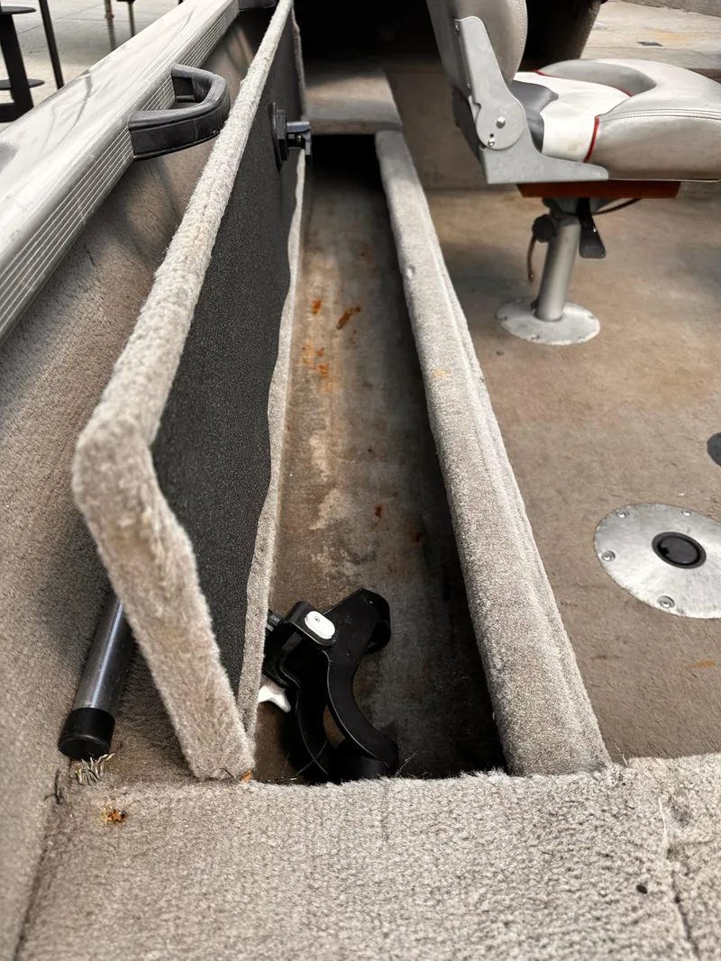 Slide: The Image of 2006 Tracker Pro Guide V-17 WT boat interior with storage compartment and seating. - 6