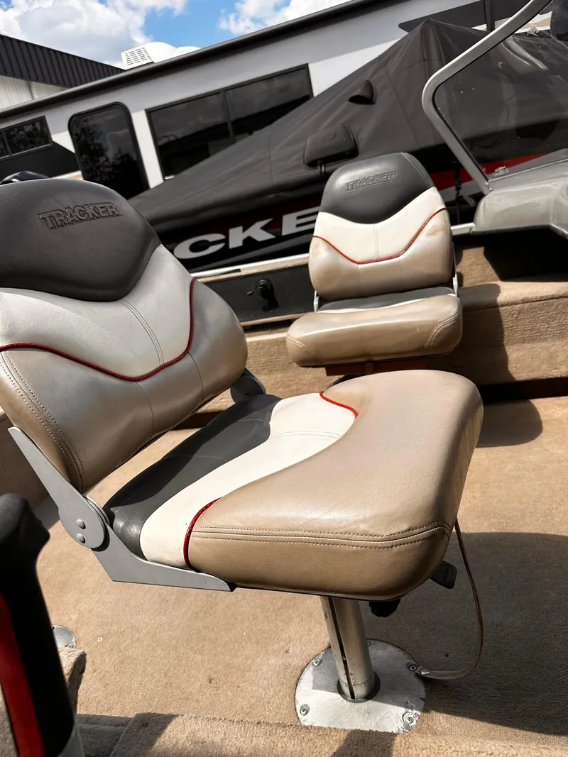 Slide: The Image of 2006 Tracker Pro Guide V-17 WT boat seats, beige and gray, with red accents. - 9