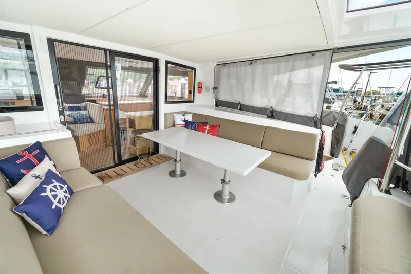 Slide: The Image of Spacious seating area on 2022 Nautitech 40 Open catamaran with nautical-themed cushions. - 10