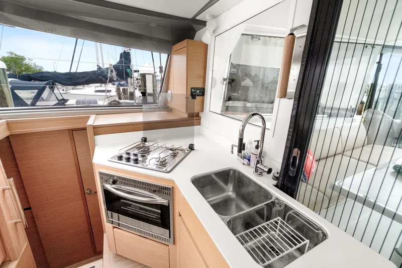 Slide: The Image of Modern kitchen in 2022 Nautitech 40 Open catamaran with stove, oven, and double sink. - 13